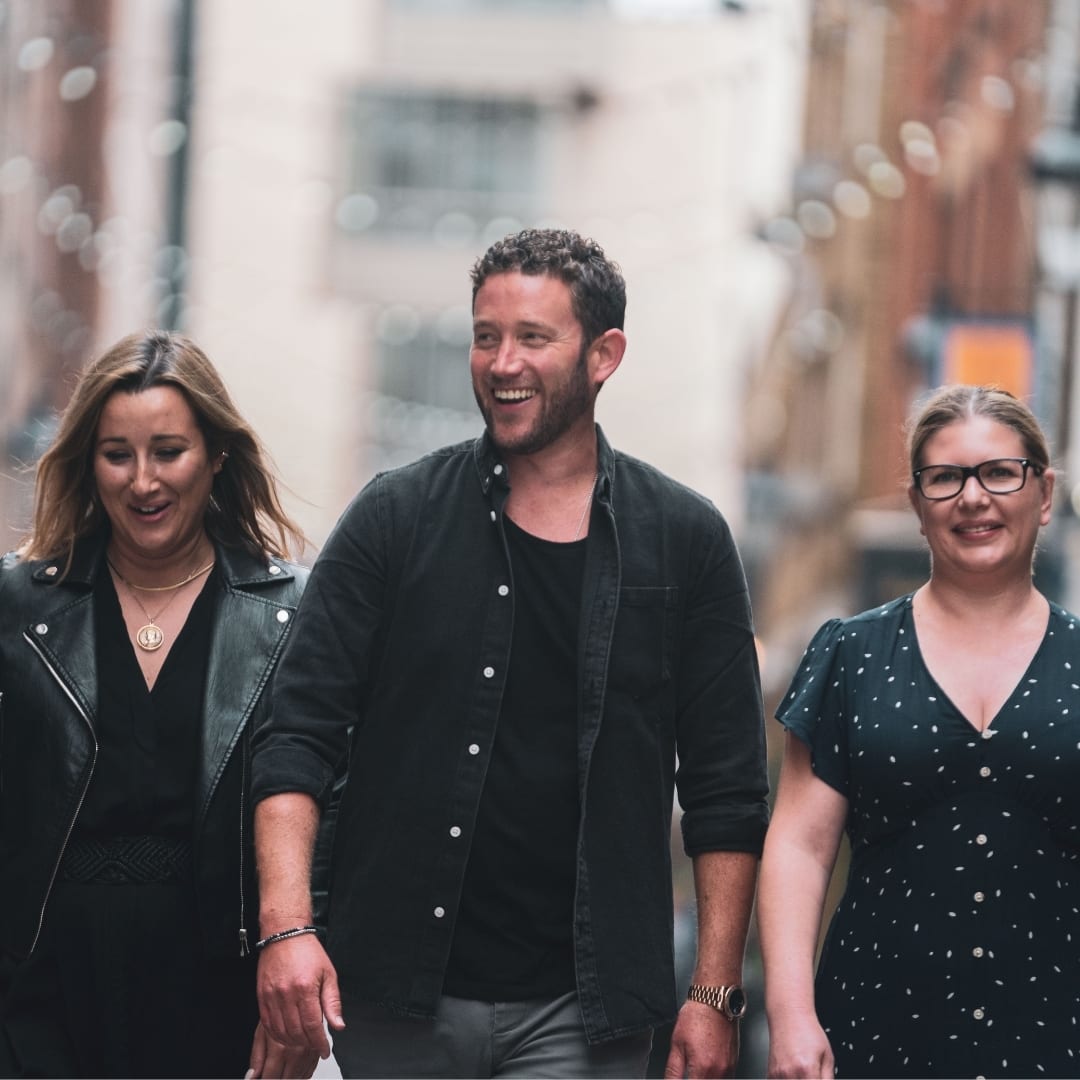 Paradise team walking down the street laughing